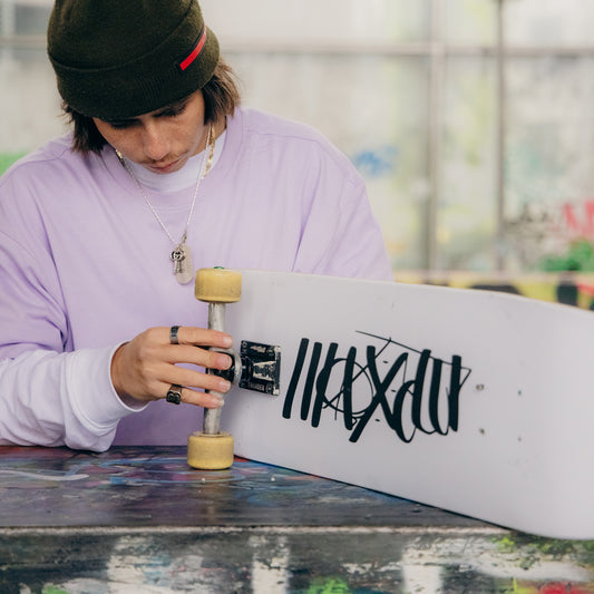 White skateboard deck with Maxolut logo detail.