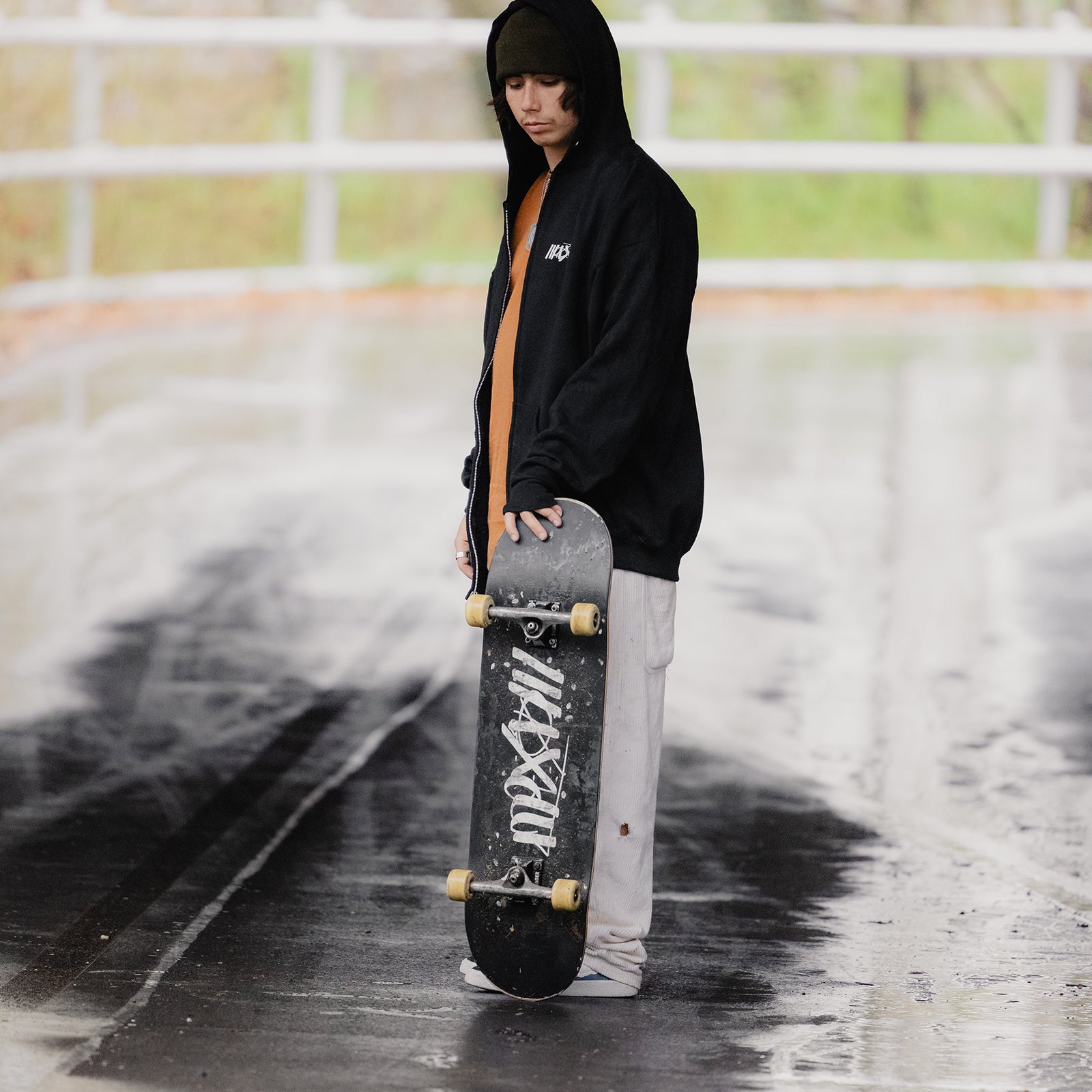 Black skateboard deck with Maxolut logo detail.