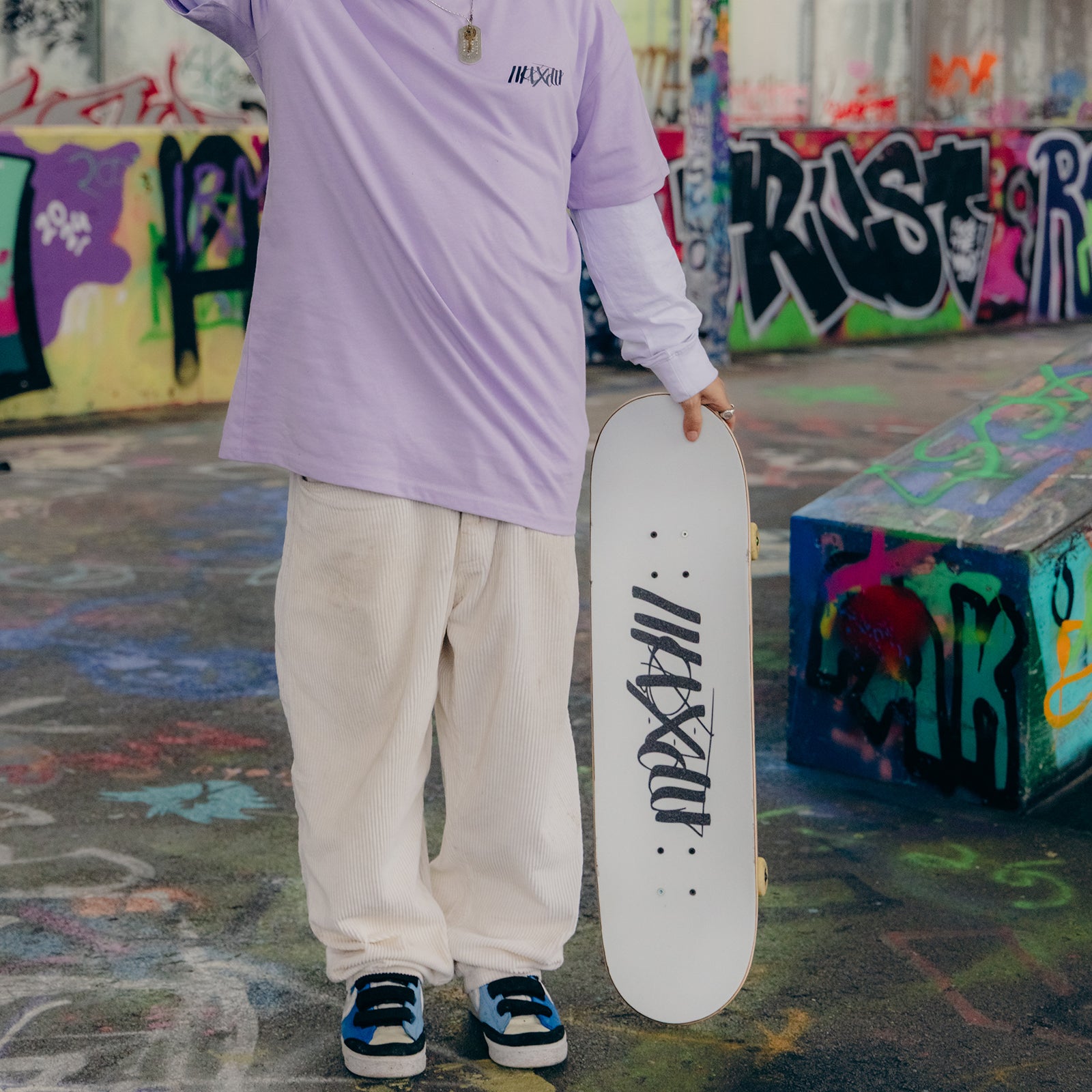 White skateboard deck with Maxolut logo detail.